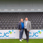Paul Gow and Mick Livesey by Pitch side CJC signage at Bromley FC