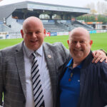 Paul Gow and Mick Livesey Pitchside CJC branded John Fiorini Stand at Bromley Football Club